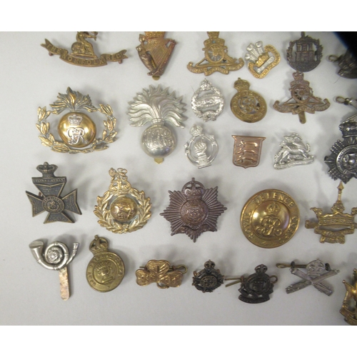 217 - Approx. fifty military cap badges and other insignia, some copies: to include Women's Transport Serv... 