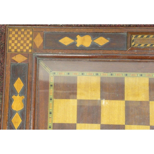 225 - A 19thC English inlaid mahogany chessboard, the border with chess related motifs and parquetry, the ... 