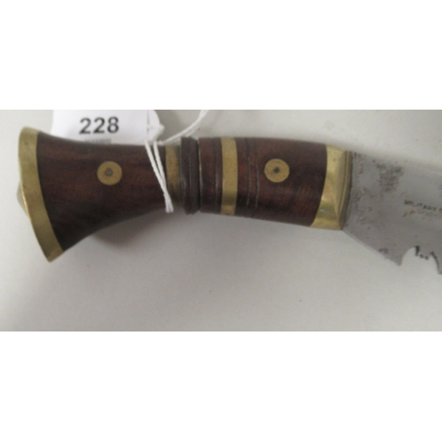 228 - An Asian Kukri with a brass mounted hardwood handle  the blade 12