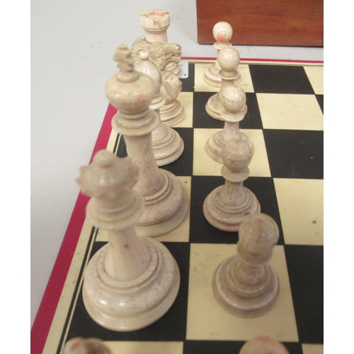 229 - A late 19thC turned naturally coloured and beetlenut stained bone Staunton pattern chess set  the ki... 