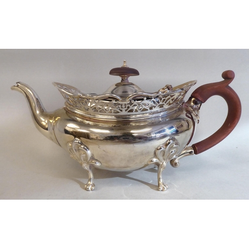 23 - A three piece silver tea set of oval, bulbous form with angled, pierced upstand rims, comprising a t... 