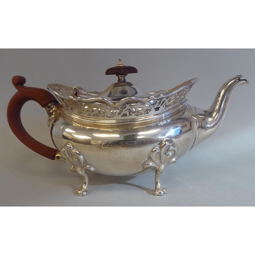 23 - A three piece silver tea set of oval, bulbous form with angled, pierced upstand rims, comprising a t... 