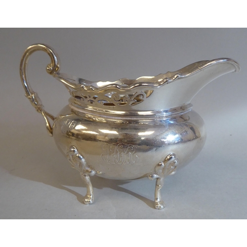 23 - A three piece silver tea set of oval, bulbous form with angled, pierced upstand rims, comprising a t... 