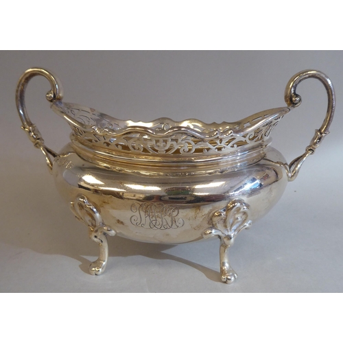 23 - A three piece silver tea set of oval, bulbous form with angled, pierced upstand rims, comprising a t... 