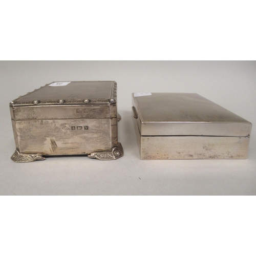 231 - A silver cigarette box with straight sides, canted corners, engine turned and applied Celtic ornamen... 