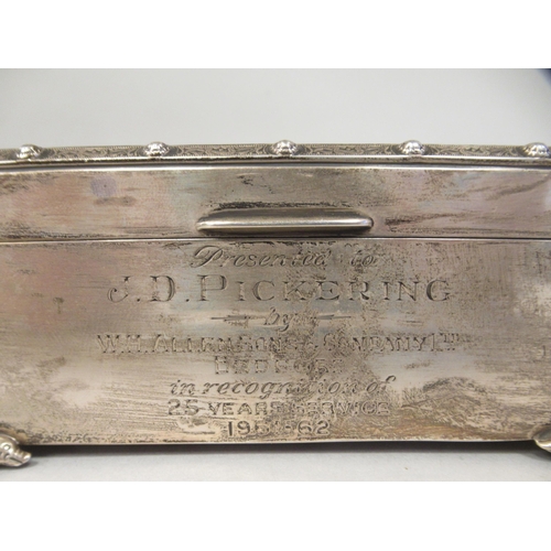 231 - A silver cigarette box with straight sides, canted corners, engine turned and applied Celtic ornamen... 