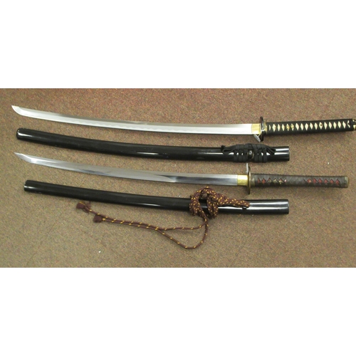 233 - Two similar 20thC Japanese swords with woven fabric bound handles and tsuba, the curved, stainless s... 