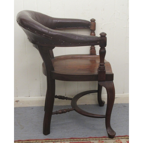 253 - A late 19th/early 20thC mahogany framed horseshoe shape desk chair, the stud upholstered rexine cres... 