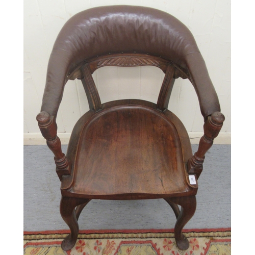 253 - A late 19th/early 20thC mahogany framed horseshoe shape desk chair, the stud upholstered rexine cres... 