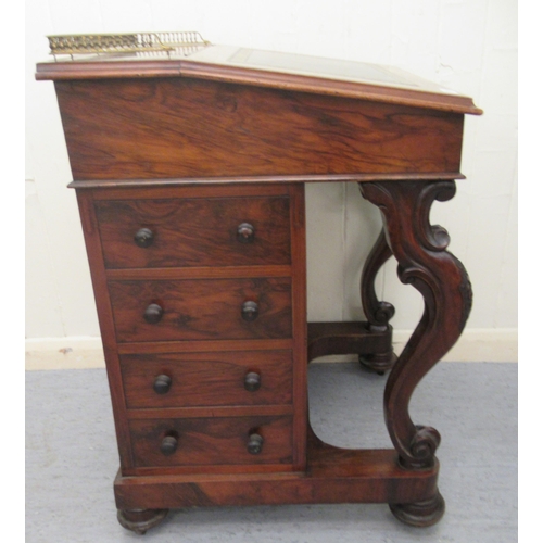 256 - A mid Victorian walnut Davenport with a brass galleried top and an angled, hinged, tooled green hide... 