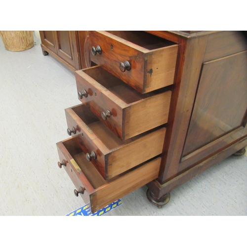 256 - A mid Victorian walnut Davenport with a brass galleried top and an angled, hinged, tooled green hide... 