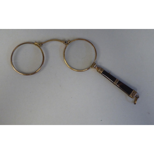 27 - Two late 19th/early 20thC yellow/gold coloured metal and tortoiseshell mounted lorgnettes 