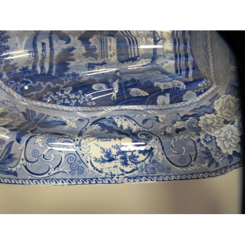 284 - A Pearlware oval meat dish with moulded channels, decorated in blue and white with a study of Netley... 