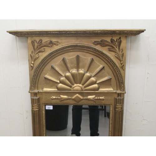 287 - A 19thC Swedish pier glass, set in a carved and gilded frame, ornamented with a fan design, foliage ... 