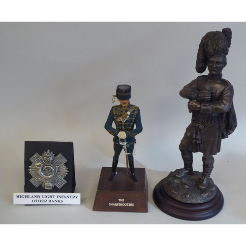 31 - Mixed military related items: to include a replica Victoria Cross; and a painted diecast standing fi... 