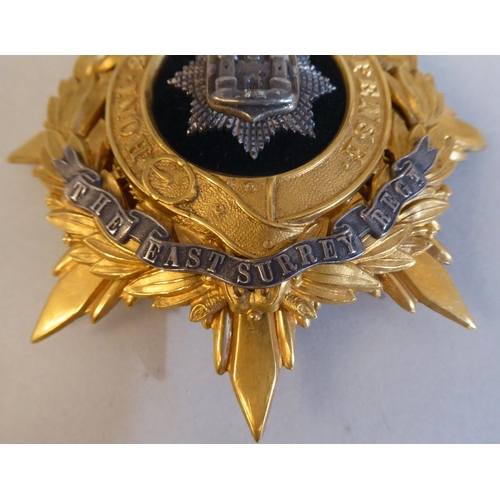 32 - An East Surrey Regiment helmet plate (Please Note: this lot is subject to the statement made in the ... 