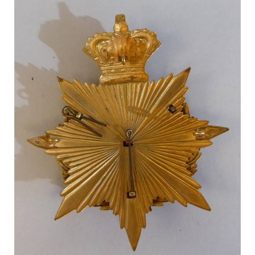 32 - An East Surrey Regiment helmet plate (Please Note: this lot is subject to the statement made in the ... 