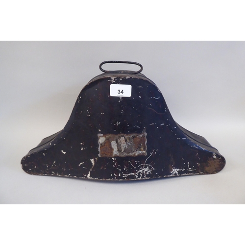 34 - A naval black cocked hat with braid and a feather plume, size 7, in a painted tinplate box (Please N... 