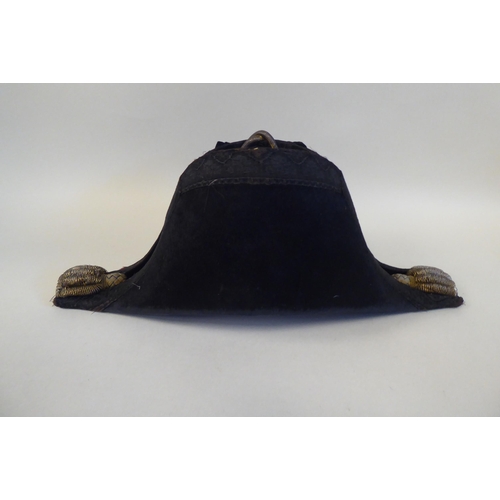 34 - A naval black cocked hat with braid and a feather plume, size 7, in a painted tinplate box (Please N... 