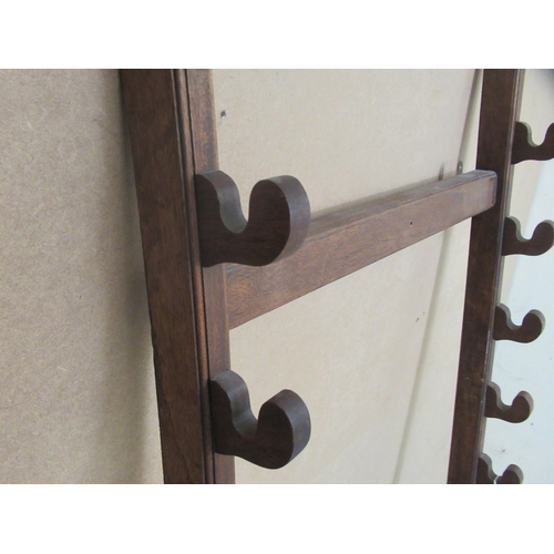 35 - A mahogany wall rack for swords/sticks with provision for ten items  55