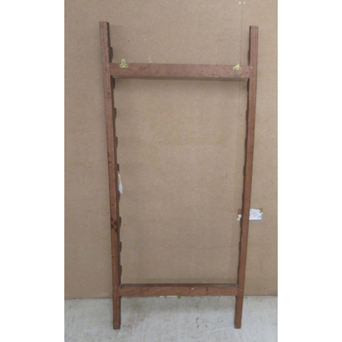 35 - A mahogany wall rack for swords/sticks with provision for ten items  55