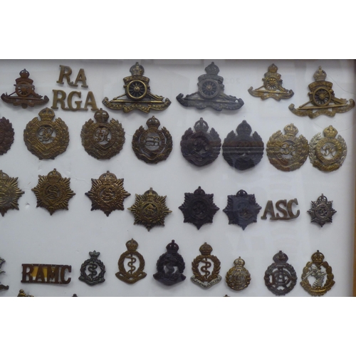 39 - Over one hundred and twenty military cap badges and other insignia, some copies: to include Royal Ar... 