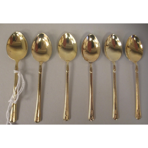 40 - A set of six silver gilt coffee spoons with individually coloured, engine turned enamel bowl backs  ... 