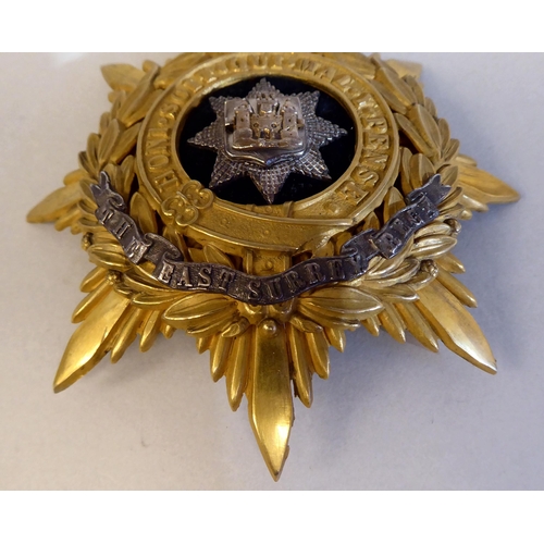 47 - An East Surrey Regiment helmet plate (Please Note: this lot is subject to the statement made in the ... 