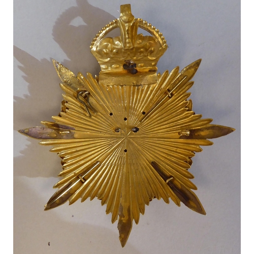 47 - An East Surrey Regiment helmet plate (Please Note: this lot is subject to the statement made in the ... 