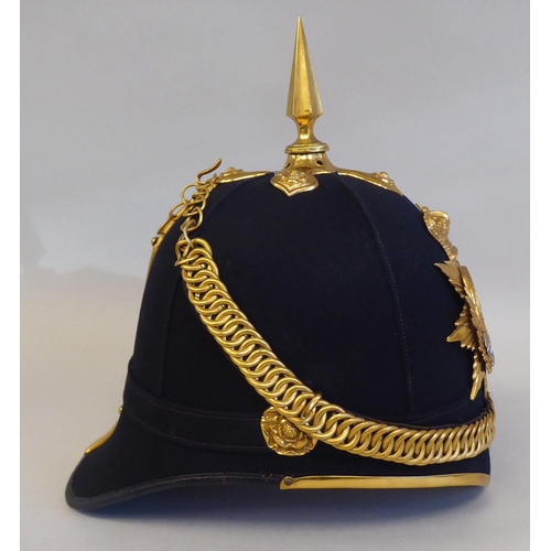 52 - A Liverpool Regiment black fabric covered helmet with gilded mounts and chinstrap  bears a J&G R... 