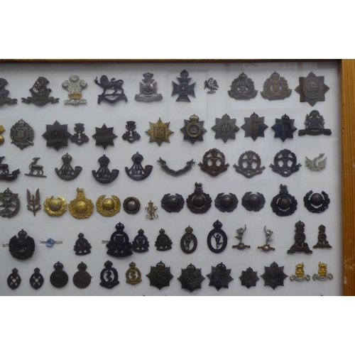 54 - Over one hundred and twenty military cap badges and other insignia, some copies: to include Lancashi... 