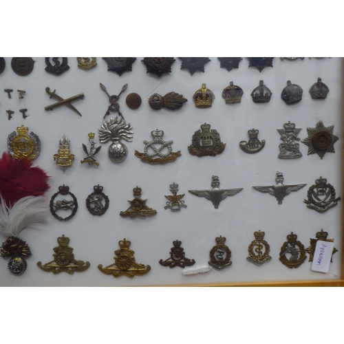 54 - Over one hundred and twenty military cap badges and other insignia, some copies: to include Lancashi... 