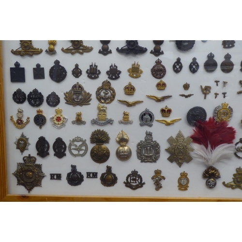 54 - Over one hundred and twenty military cap badges and other insignia, some copies: to include Lancashi... 