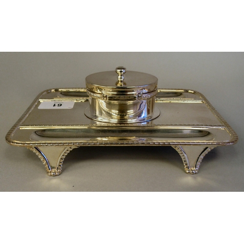 61 - A Georgian style silver standish, the rectangular tray base with a gadrooned border, two pen channel... 