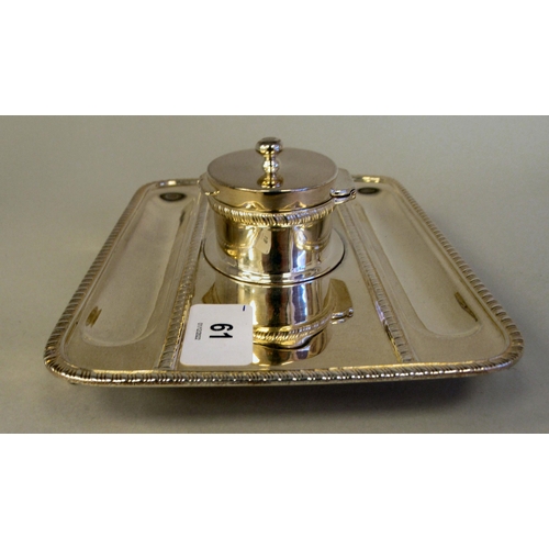 61 - A Georgian style silver standish, the rectangular tray base with a gadrooned border, two pen channel... 