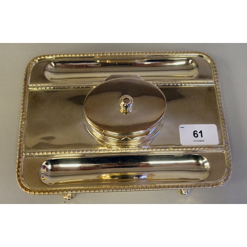 61 - A Georgian style silver standish, the rectangular tray base with a gadrooned border, two pen channel... 