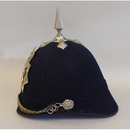 63 - A Black Watch black fabric covered helmet with a chinstrap  bears a Dolan & Co London label (Ple... 