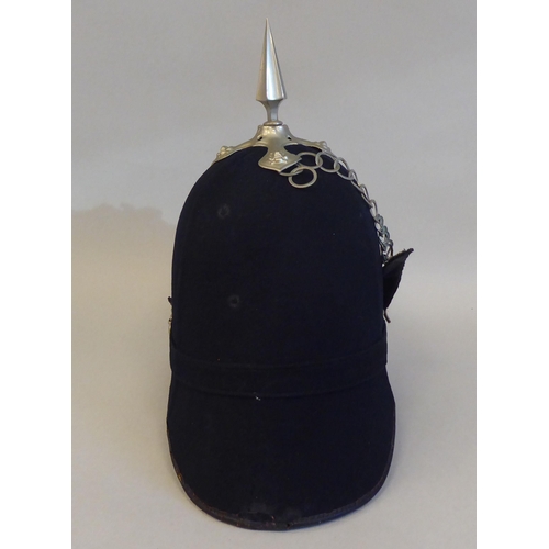 63 - A Black Watch black fabric covered helmet with a chinstrap  bears a Dolan & Co London label (Ple... 