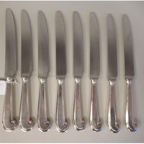 65 - A set of eight silver pistol grip handled table knives with stainless steel blades; and a matching s... 