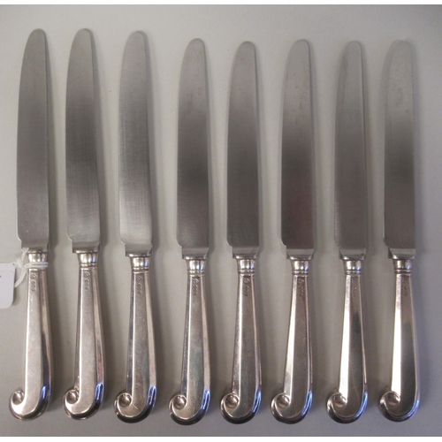 65 - A set of eight silver pistol grip handled table knives with stainless steel blades; and a matching s... 