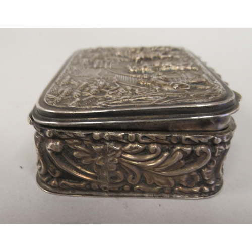 67 - An Edwardian silver trinket box with straight sides and a hinged lid, repousse worked with 18thC fig... 