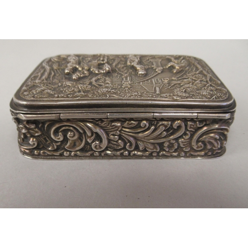 67 - An Edwardian silver trinket box with straight sides and a hinged lid, repousse worked with 18thC fig... 