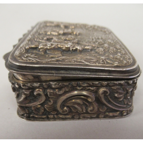 67 - An Edwardian silver trinket box with straight sides and a hinged lid, repousse worked with 18thC fig... 