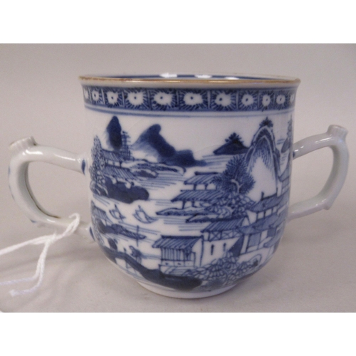 69 - A late 18thC Chinese porcelain twin handled cup and cover, decorated in blue and white with figures,... 