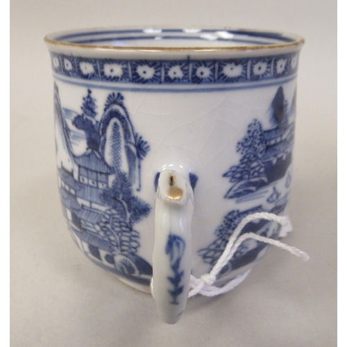 69 - A late 18thC Chinese porcelain twin handled cup and cover, decorated in blue and white with figures,... 