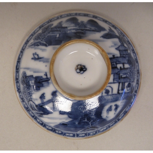 69 - A late 18thC Chinese porcelain twin handled cup and cover, decorated in blue and white with figures,... 