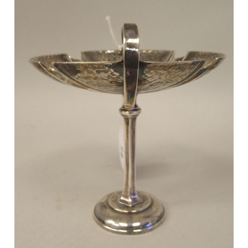 72 - An Art Nouveau silver pedestal sweet dish with opposing looped wire handles, elevated on a slender o... 