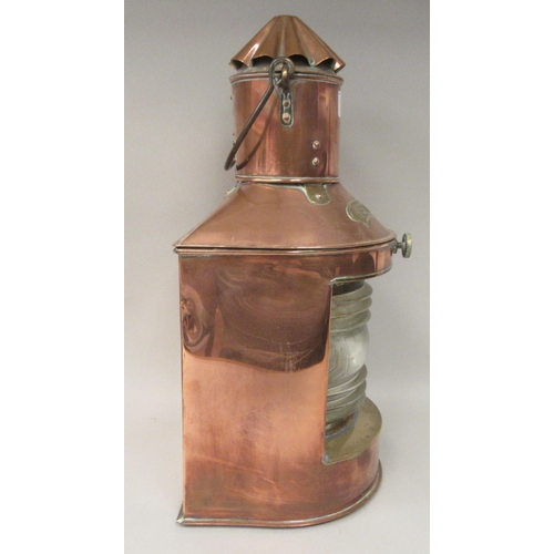 75 - A late 19th/early 20thC copper and brass cased ships stern lantern with a chimney and a clear, rib m... 