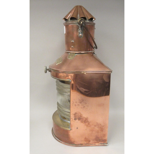 75 - A late 19th/early 20thC copper and brass cased ships stern lantern with a chimney and a clear, rib m... 