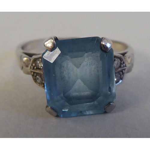 81 - A white gold claw set ring with a single stone aquamarine and diamond ring  stamped 18ct; and a whit... 